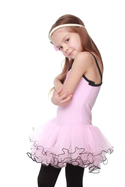 Elegance dancer in a ballerina costume Studio image of a charming dancer with beautiful hair in a pink tutu smiling and dancing on white background — Stock Photo, Image