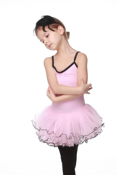 Cute little ballet dancer with beautiful hair standing in a ballet pose — Stock Photo, Image