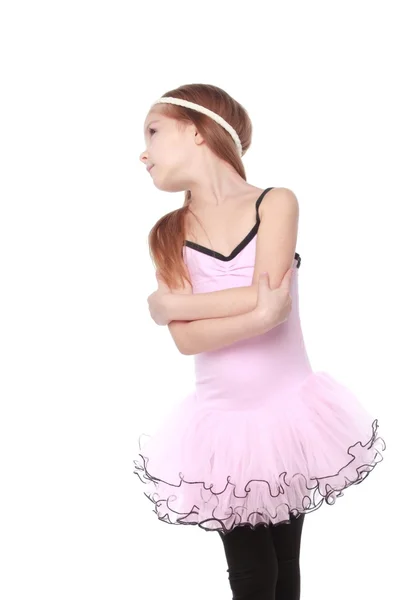 Portrait of a smiling little dancer in pink tutu standing in a ballet pose — Stock Photo, Image