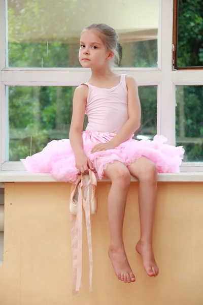 Beautiful little ballerina wearing tutu and posing on camera — Stock Photo, Image