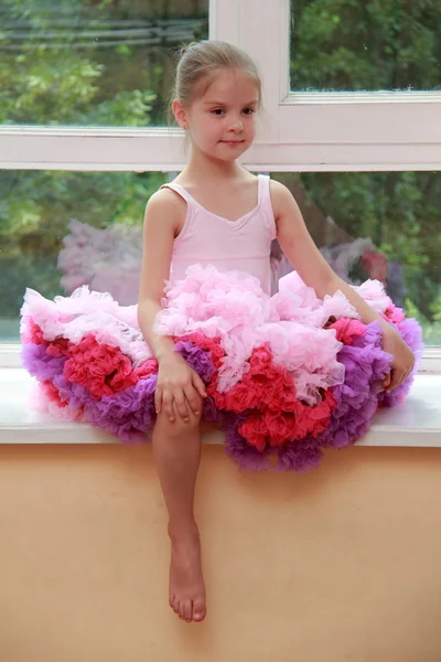 Romantic dreaming young girl dressed luxuriant ball dress with frill sitting on white windowsill — Stock Photo, Image