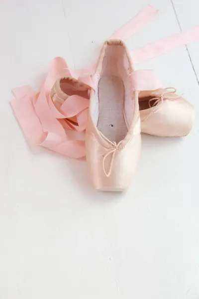 Pink pointe shoes on an old window sill — Stock Photo, Image