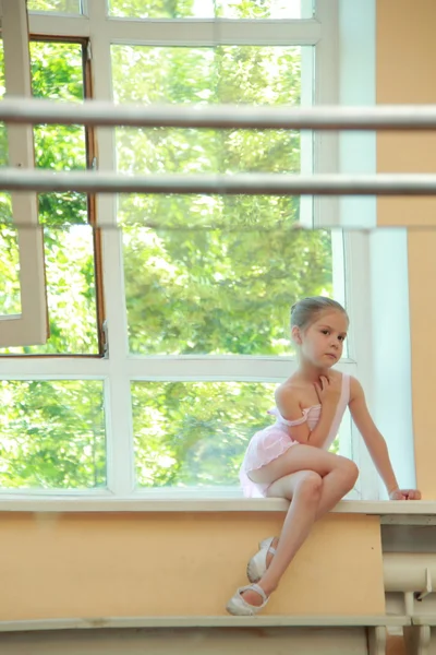 Beautiful little ballerina wearing tutu and posing on camera — Stock Photo, Image