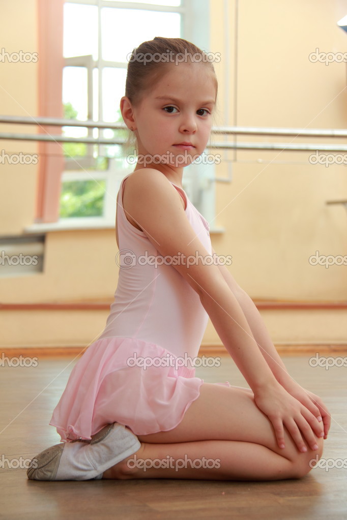 Young girl engaged in a pink ballet tutu and pointe in the ballet hall