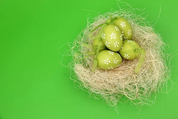 Green egg with a pattern in the Easter basket — Stock Photo, Image