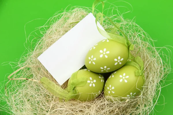Greeting card on the theme of Easter colored eggs and white card for text — Stock Photo, Image