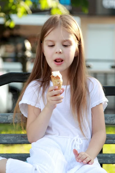 Young girl with long hair is white ice cream and smiling outdoors — Stock Photo, Image