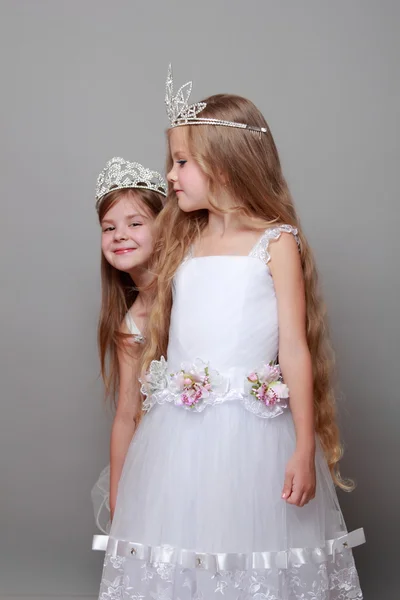 Sonrientes niñas lindas en vestidos blancos y una corona para el concurso de belleza — Foto de Stock