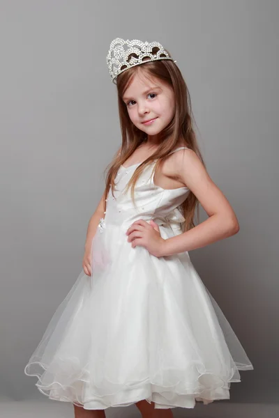 European cute young girl wearing a crown and a white dress with a cute smile on Holiday — Stock Photo, Image