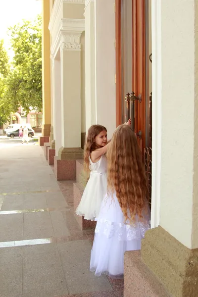 Küçük kızlar açık havada uzun saçlı beyaz elbiseler — Stok fotoğraf