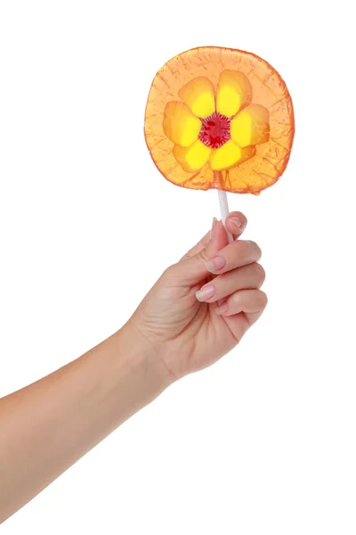 Baby hand holding a lollipop isolated on white — Stock Photo, Image