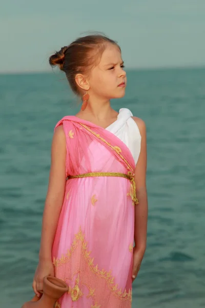 Smiling cute little girl in a beautiful dress in Greek style — Stock Photo, Image