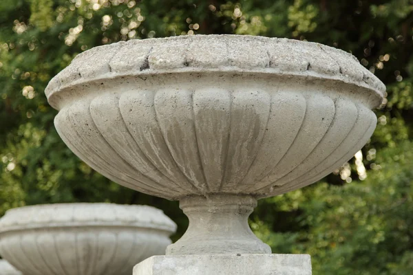 Old stone vase stands on the railing of the stairs, decorative architectural element — Stock Photo, Image