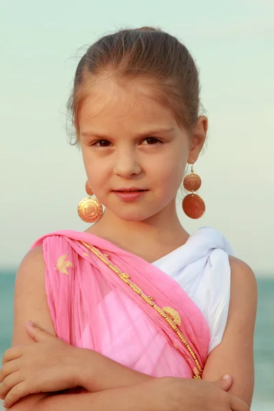 Sweet gentle young girl with a sweet smile and beautiful earrings — Stock Photo, Image