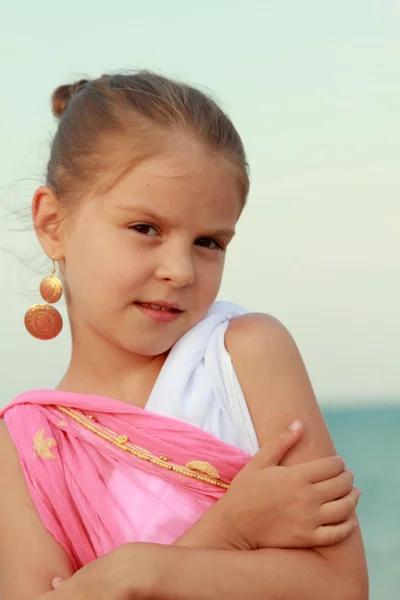 Sweet gentle young girl with a sweet smile and beautiful earrings — Stock Photo, Image