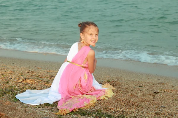 Smiling cute little girl in a beautiful dress in Greek style — Stock Photo, Image
