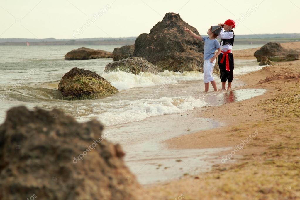 Charming young children in fancy dress playing pirates