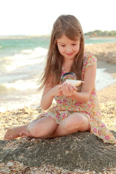 Belle fille avec un beau sourire jouant pieds nus dans l'eau sur la plage . — Photo