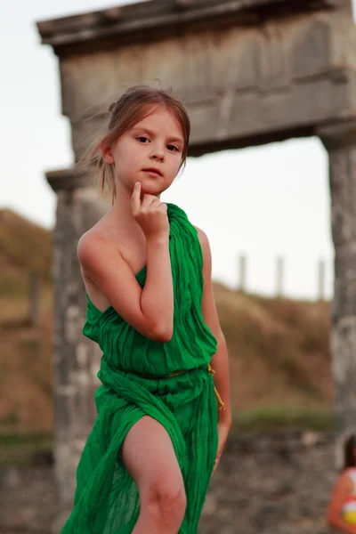 Beautiful little Greek goddess in emerald green dress. — Stock Photo, Image