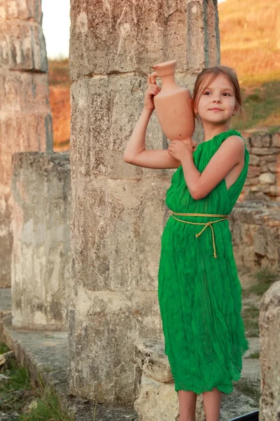 Beautiful little Greek goddess in emerald green dress. — Stock Photo, Image