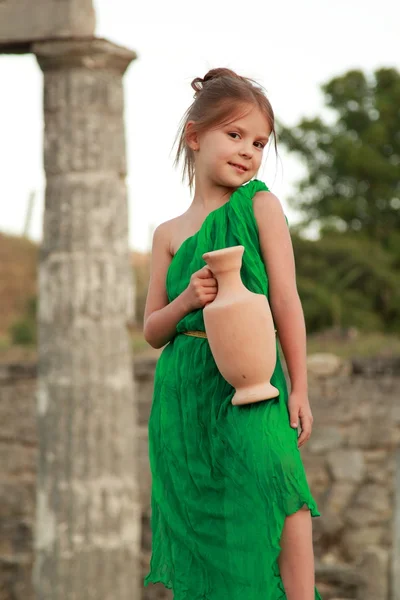 Beautiful little Greek goddess in emerald green dress. — Stock Photo, Image