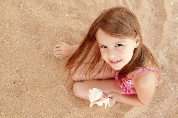 Portrait of adorable little girl with a seashell. — Stock Photo, Image