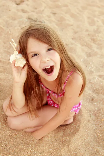 Portrait of adorable little girl with a seashell — Stock Photo, Image