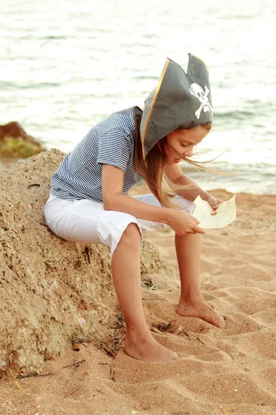 Evil emotional young girl in a hat with the symbol of piracy — Stock Photo, Image