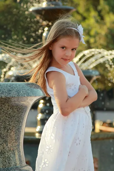 Kaukasische mooi glimlachend kind meisje in de buurt van fontein in sammer — Stockfoto