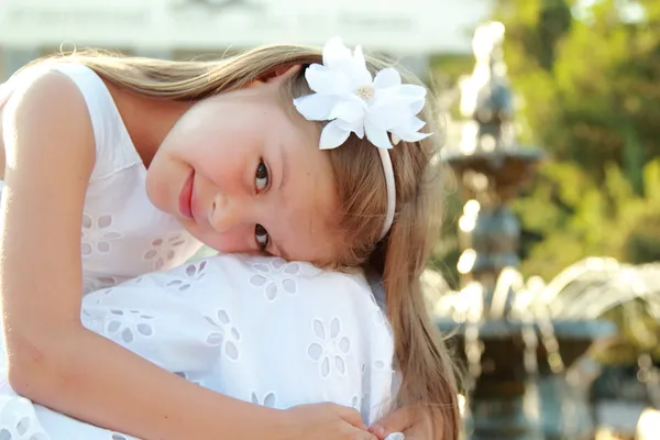 European smiling young girl with beautiful hair in a white summer dress — Stock Photo, Image
