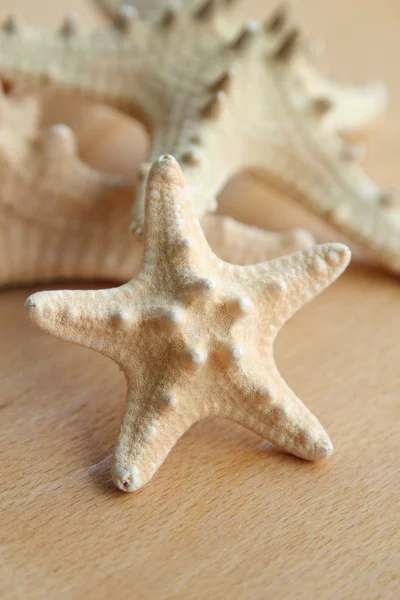 Beautiful sea stars on wooden background — Stock Photo, Image