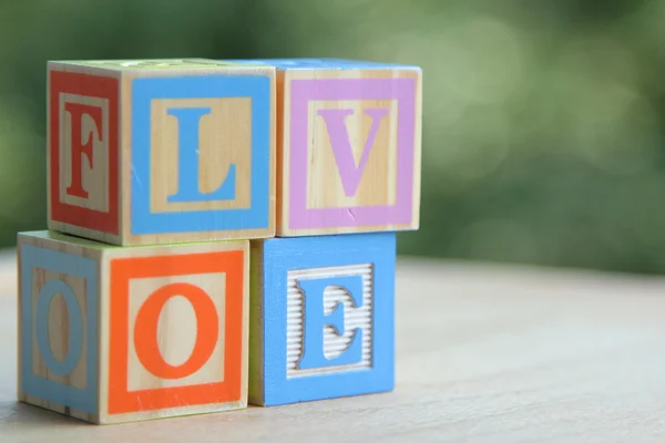 Alphabet blocks arranged to spell the word, "love" — Stock Photo, Image