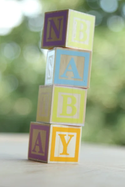 Word baby lined with children 's wooden blocks for elementary education alphabet — стоковое фото