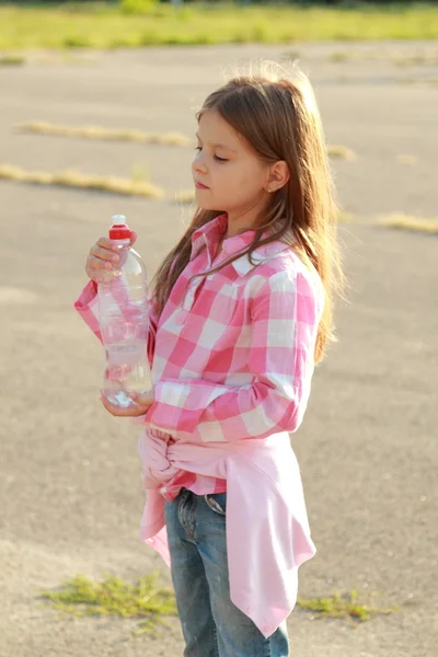 Cute little girl drinks water — Stock Photo, Image