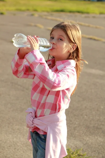 Cute little girl drinks water — Stock Photo, Image