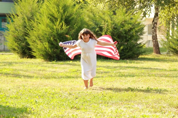 Mädchen mit einer großen amerikanischen Flagge — Stockfoto