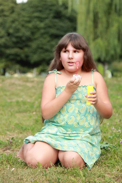 Adorable Happy Little Girl Sitting Grass Blowing Soap Bubbles — Stock Photo, Image