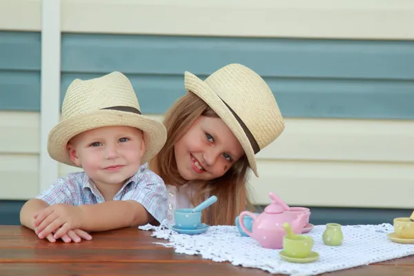 Little brother and sister playing with toys — Stock Photo, Image