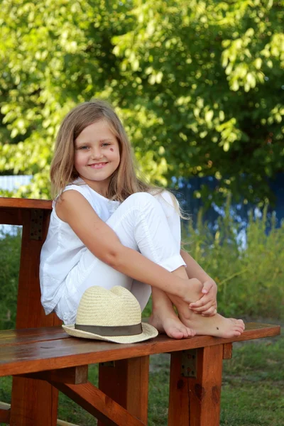 Little girl in the yard on a summer day — Stock Photo, Image