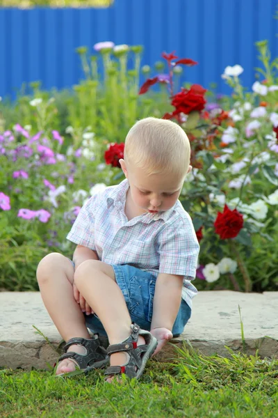 Little boy sitting on the track — Stock Photo, Image