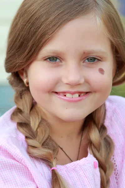 Smiling child with two braids — Stock Photo, Image