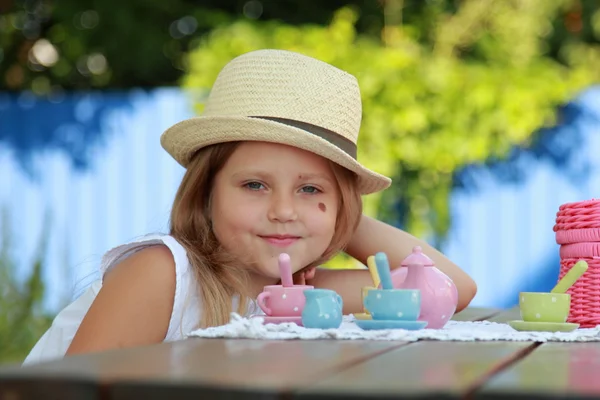 Kleines Mädchen spielt mit ihrem Spielzeug auf dem Hinterhof — Stockfoto