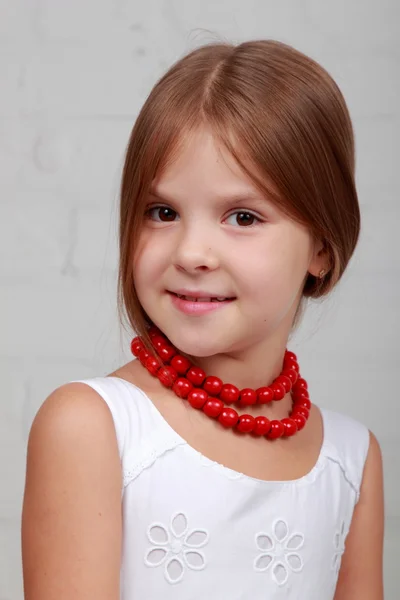 Portrait of child with red beads — Stock Photo, Image