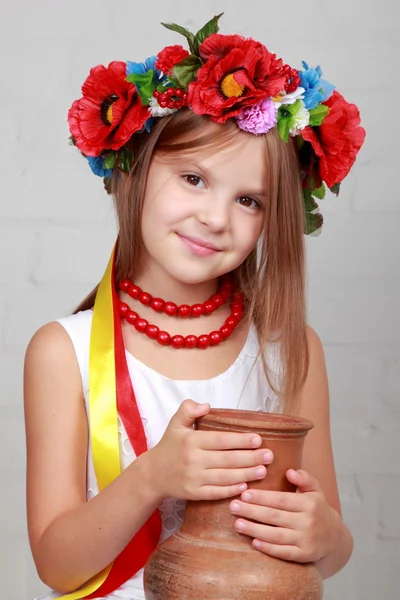 Ukrainian child in a suit holding a pitcher — Stock Photo, Image