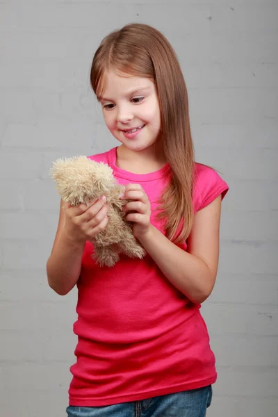 Malá dívka vytěžený medvěd toy — Stock fotografie