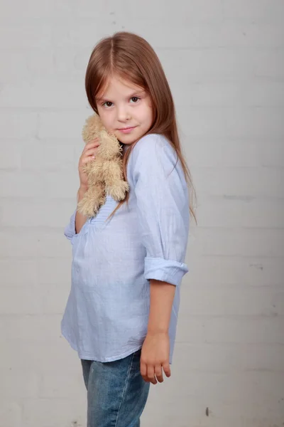 Little girl hugging bear toy — Stock Photo, Image