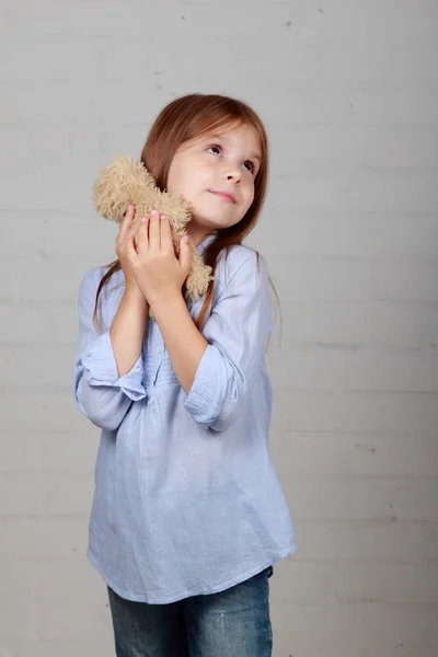 Little girl hugging bear toy — Stock Photo, Image