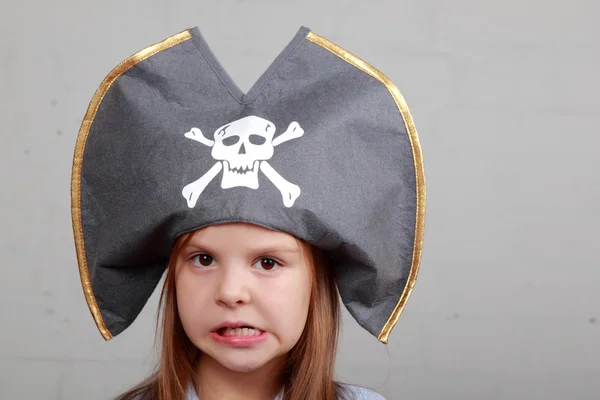Terrible pirate girl in shirt and hat on a gray background — Stock Photo, Image