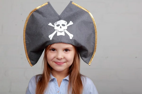 Menina pirata terrível na camisa e chapéu em um fundo cinza — Fotografia de Stock
