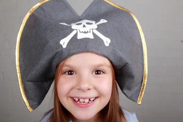 Terrible pirate girl in shirt and hat on a gray background — Stock Photo, Image